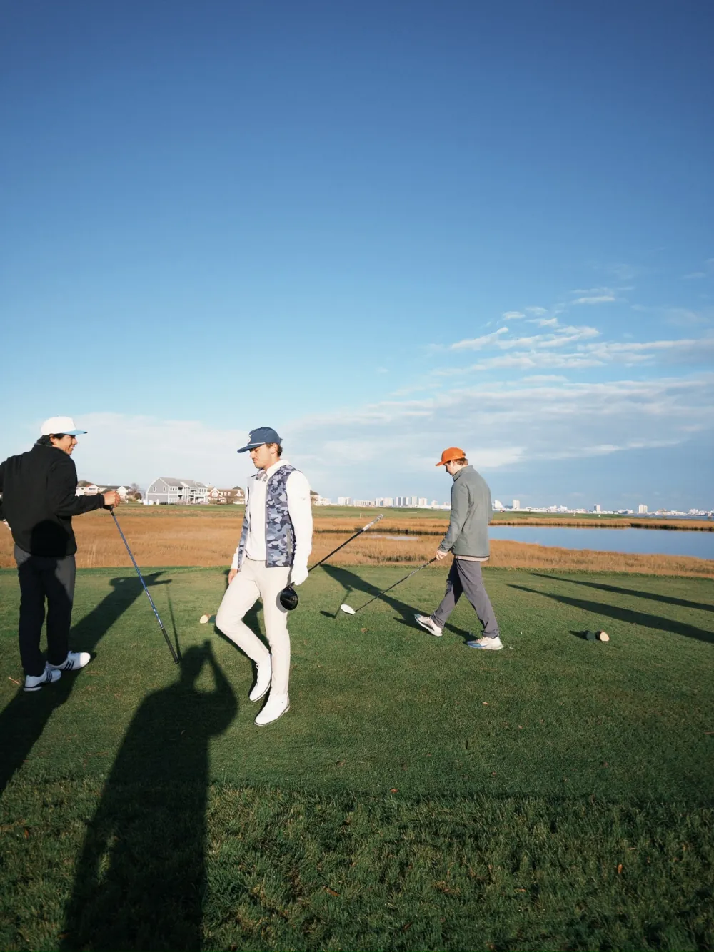 Walking the tee box, long shadows, the Ocean City skyline in the distance