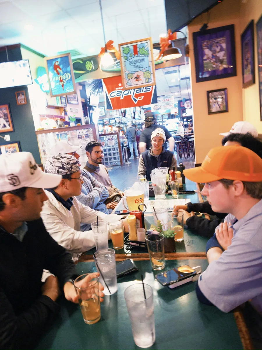 Packed around the table at the sports bar after the round