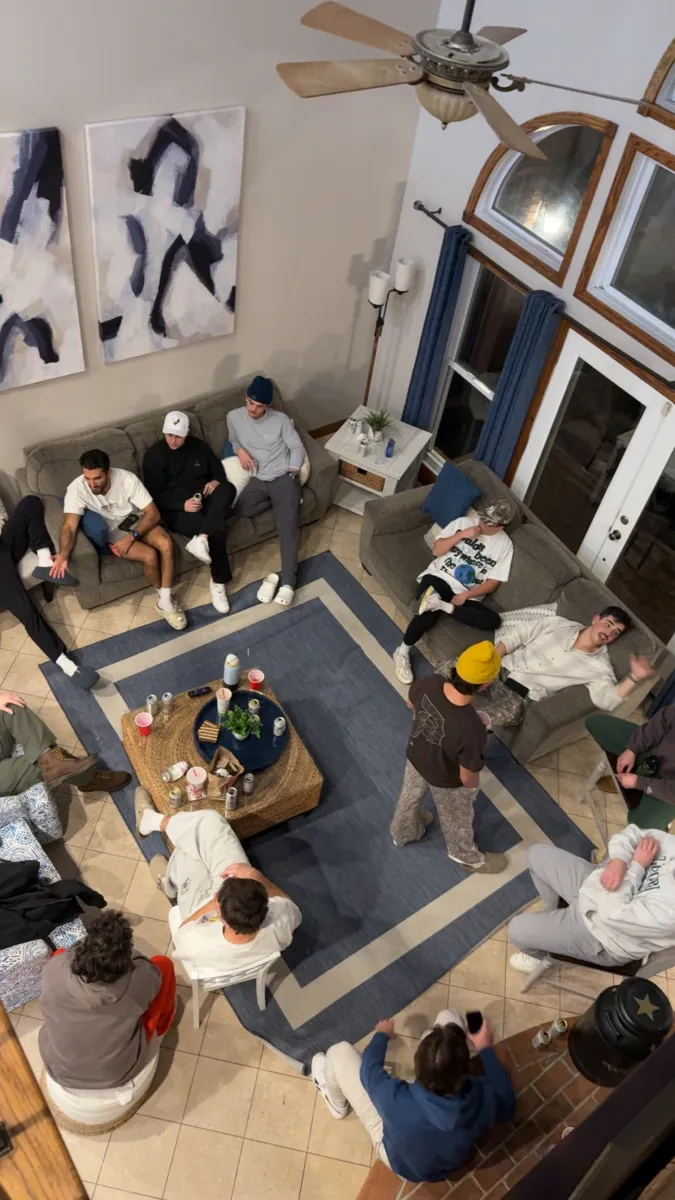 The whole crew sprawled around the living room, shot from above