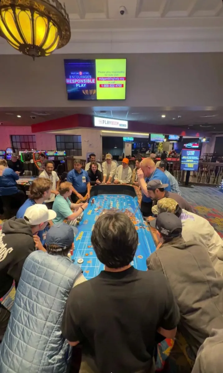 The whole group crowded around the craps table on casino night